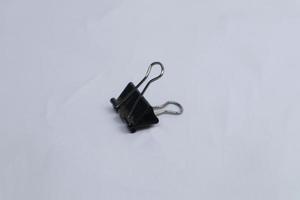 black paper clip isolated on white photo