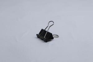 black paper clip isolated on white photo