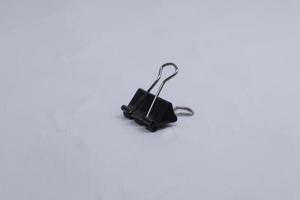 black paper clip isolated on white photo