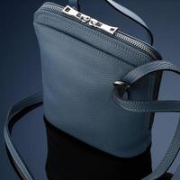 A closeup shot of a luxury blue leather bag photo