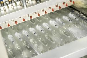 A closeup of the production of medical syringes photo