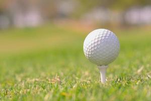 A closeup shot of a white golf ball in a course photo