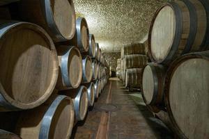 The wooden wine barrels in a wine factory photo