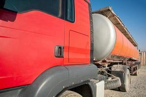A closeup gas red tanker truck at an industrial construction site photo