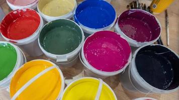 A closeup shot of colorful paints in buckets photo