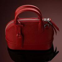 A closeup shot of a luxury red leather bag photo