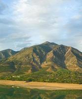 A vertical shot of mountains against the background of the cloudy sky. Central Asia photo