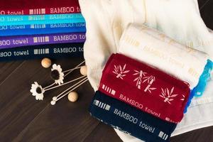 A closeup shot of folded colorful bamboo towels on a bathroom floor photo