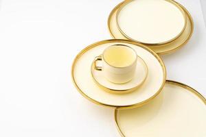 A set of golden luxury ceramic kitchen utensils on a white background photo