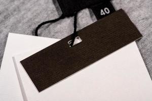 A closeup shot of a blank clothing tag on a string for a price label on a cloth photo