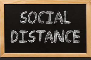 Social distance text on blackboard photo
