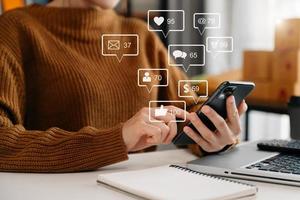 Social media and Marketing virtual icons screen concept.close up of businesswoman typing keyboard tablet with laptop computer  and smart phone photo