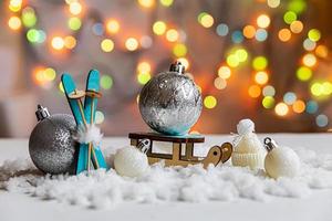 Abstract Advent Christmas Background. Winter decorations ornaments toys and balls on background with snow and defocused garland lights. Merry Christmas time concept. photo