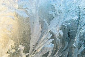 Frozen winter window with shiny ice frost pattern texture. Christmas wonder symbol, abstract background. Extreme north low temperature, natural Ice snow on frosty glass, cool winter weather outdoor. photo