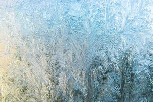 Frozen winter window with shiny ice frost pattern texture. Christmas wonder symbol, abstract background. Extreme north low temperature, natural Ice snow on frosty glass, cool winter weather outdoor. photo