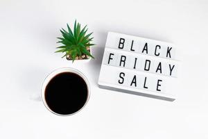 Black Friday concept. Cup of coffee and lightbox on white background. Sale and discount photo