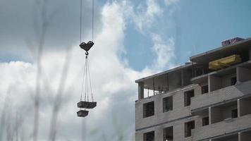 Big industrial construction crane with beautiful cloudy sky background. City development video