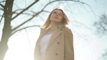 Portrait, Pretty Blonde Business Woman Looking Confident in Brown Coat Backlit by Bright Sunlight. Career People. Fashion, Beauty. Female Portraits. Real People. Slow Motion video
