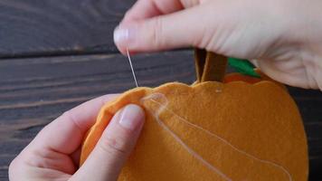 Autumn decorations made of felt for the home. Decorative pumpkins for Halloween. video