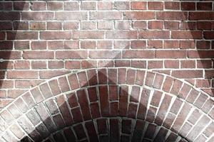 Aged and weathered brick wall textures with very bright spotlight illumination photo