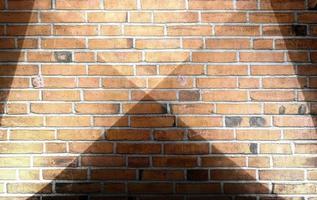 Aged and weathered brick wall textures with very bright spotlight illumination photo