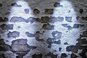 Aged and weathered brick wall textures with very bright spotlight illumination photo