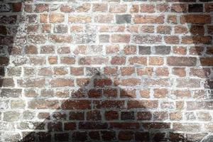 Aged and weathered brick wall textures with very bright spotlight illumination photo