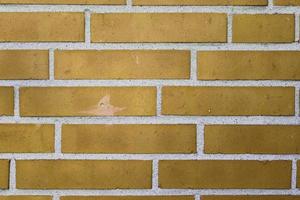 Detailed view at a colorful old and weathered brick wall texture as a panoramic background. photo