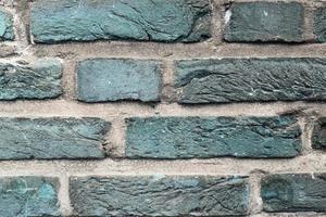 Detailed view at a colorful old and weathered brick wall texture as a panoramic background. photo