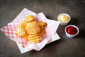 waffle fries with ketchup and mayonnaise photo