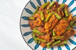 Stir fried pork with red curry paste photo