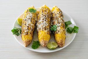 barbecue and grilled corn with cheese and lime photo