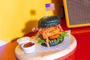 barbecue burger - pork with barbecue sauce with cheese, onion rings and bacon burger photo
