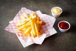 French fries with ketchup and mayonnaise photo