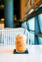 Thai tea ice scoop in glass photo