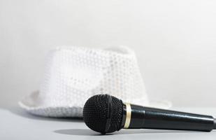 A glittery silver sequin party hat and microphone. Bright paillette hat and presenter microphone. show host accessories. photo