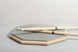 Pair of drumsticks, training pad, practicing for drummers. Copy paste. Music learning concept photo