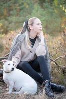 Young attractive woman playing with dog photo