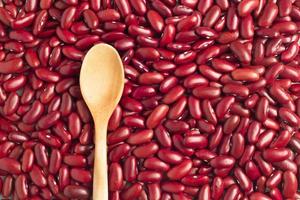 Close-up photo of several red kidney beans  and wooden spoon,top view,flay lay,top-down.