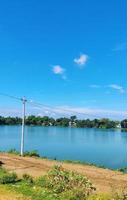 Beautiful shot of a lake surrounded by greenery under a cloudy sky photo