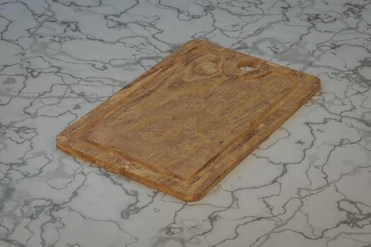 una vieja tabla de cortar se encuentra en la superficie de la mesa de la cocina. foto