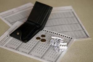 Crumpled lottery tickets and empty purse as symbol of losing the lottery game. Unlucky gambling results. Misfortune photo