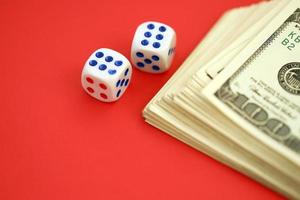 Money, finance and gambling concept. Close up on an American hundred US dollar banknotes and two white dice on top showing the numbers six photo