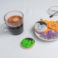 hot espresso coffee  or chocolate cup with funny Halloween Cookies. Happy Halloween day, Trick or Threat, Hello October, fall autumn, Traditional, party and holiday concept photo