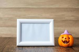 Orange pumpkin on table and frame with copy space for text. Happy Halloween day, Hello October, fall autumn season, Festive, party and holiday concept photo