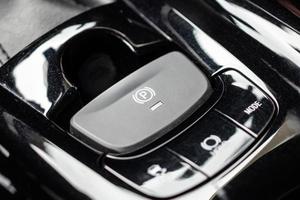 electronic handbrake button in luxury modern car photo