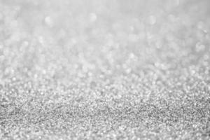 Abstract blur silver glitter sparkle defocused bokeh light background photo