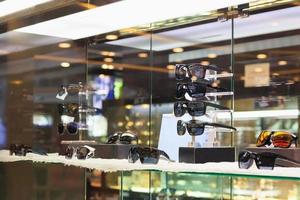 glasses and eyeglasses show in luxury retail optical store window display showcase photo