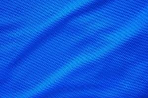 Blue football jersey clothing fabric texture sports wear background, close up top view photo