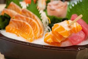 Raw salmon sashimi slice on ice Japanese food photo